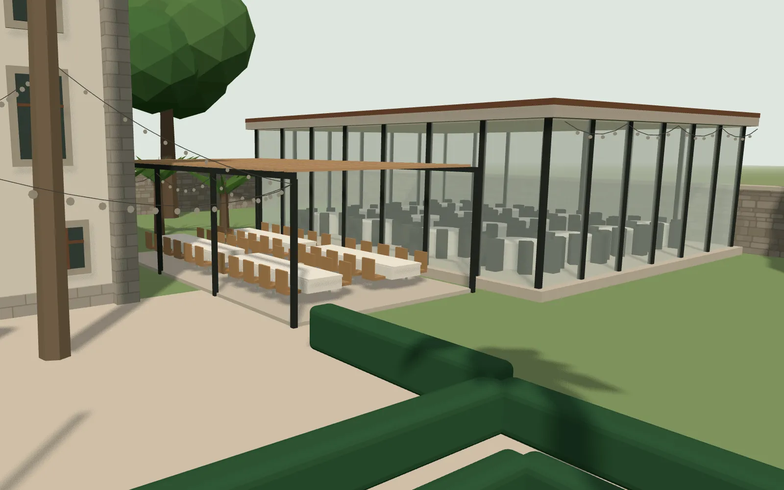 La terraza cubierta con mesas largas junto al jardín, en la maqueta